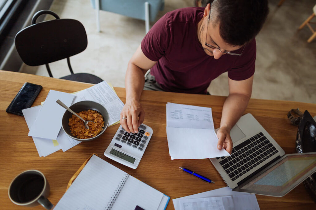 man making calculations at the dinner table