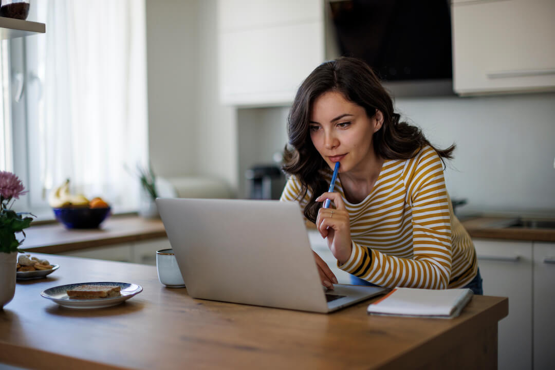 woman doing online research in the kitchen