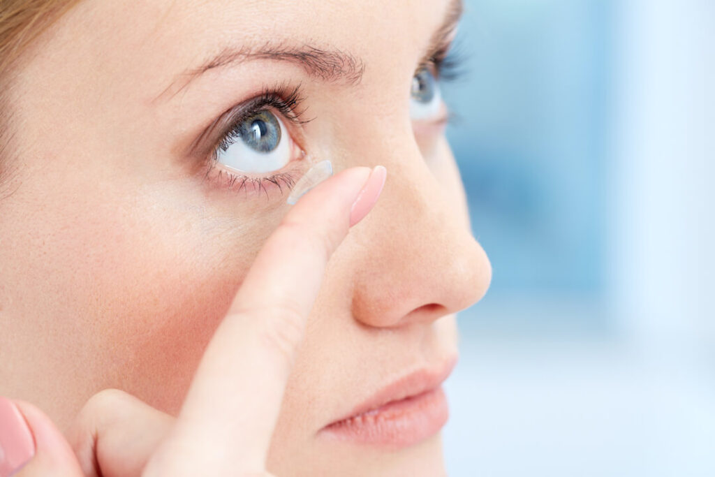 woman putting in contact lenses