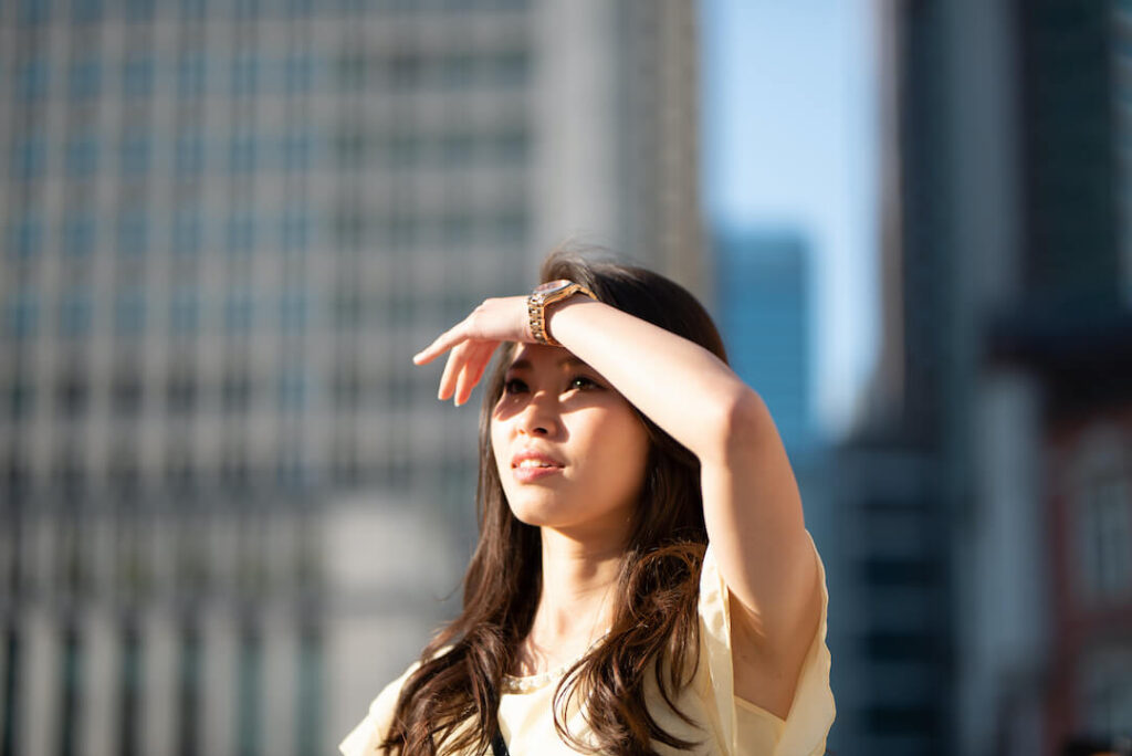 woman shielding herself from bright sunlight