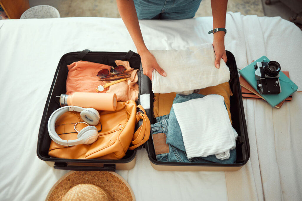 person packing a large bag