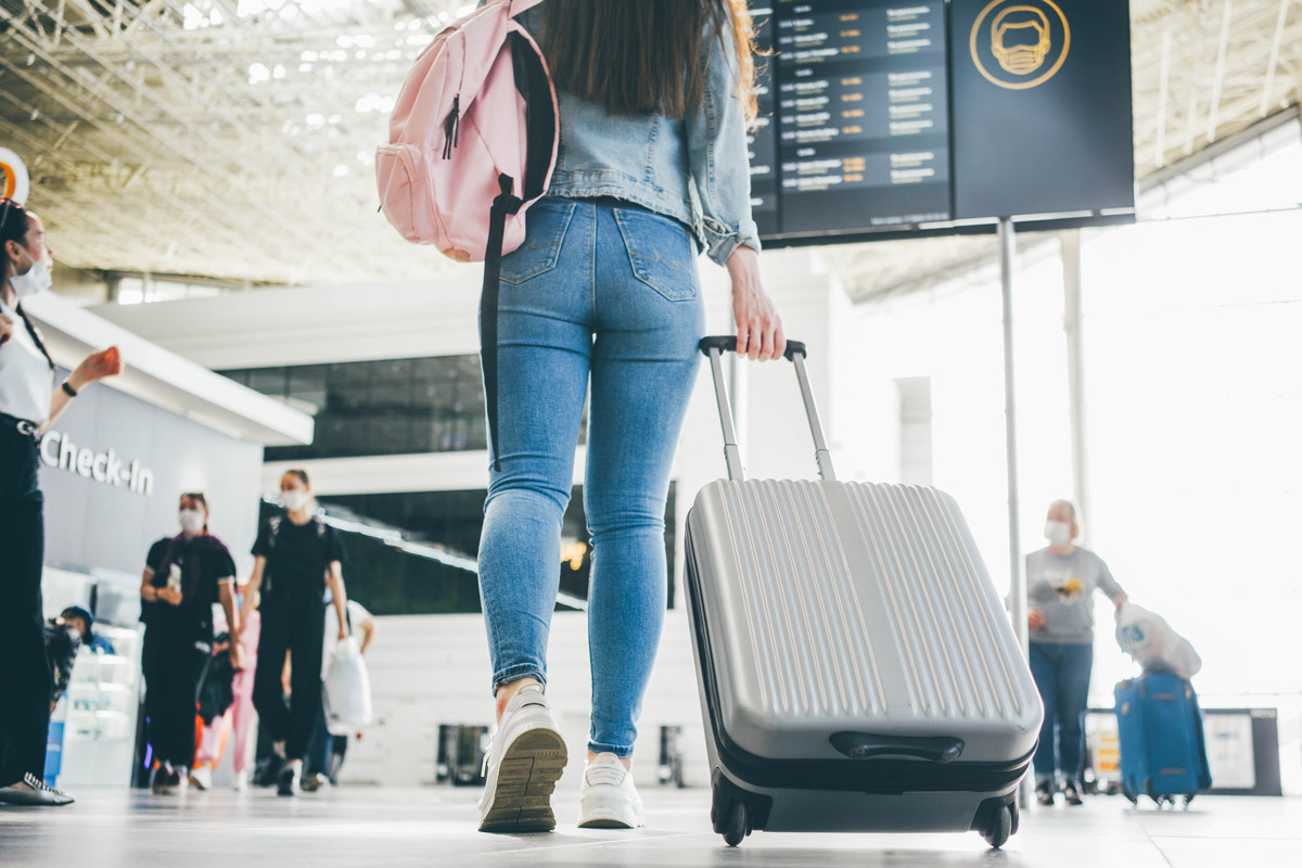 woman traveling through an airport to TSA