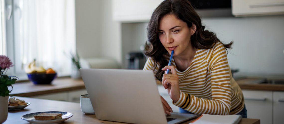 woman doing online research in the kitchen