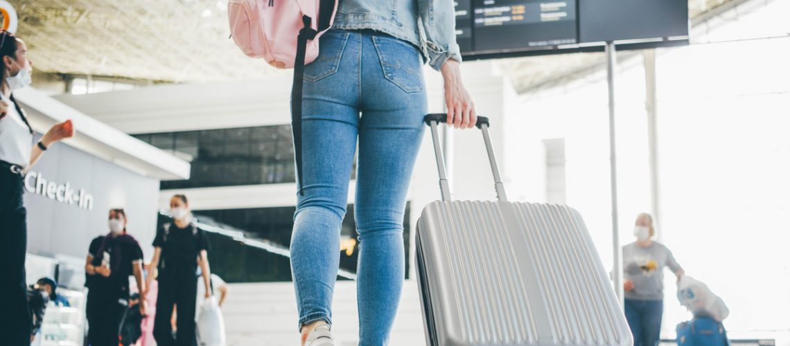 woman traveling through an airport to TSA